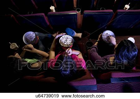 Stock Photo - Girls watching a movie . Fotosearch