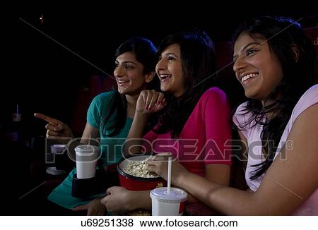 Stock Photo - Girls watching a movie . Fotosearch