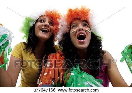 Stock Photograph - Girls with wigs cheering . Fotosearch