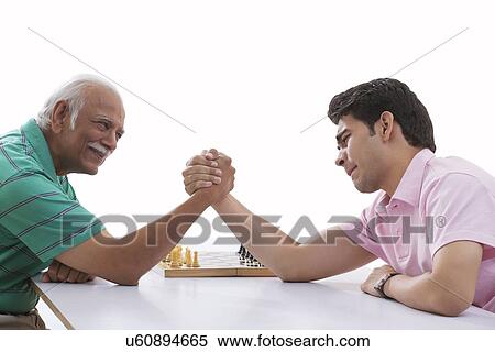 Grandfather and grandson doing arm wrestling View Large Photo Image Stock Photography - Grandfather and grandson doing arm wrestling. Fotosearch