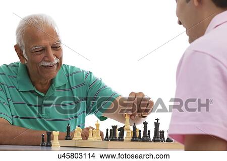Grandfather and grandson playing chess View Large Photo Image Picture - Grandfather and grandson playing chess. Fotosearch