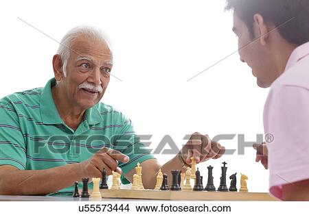 Grandfather and grandson playing chess View Large Photo Image Picture - Grandfather and grandson playing chess. Fotosearch