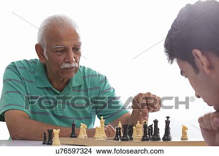 Grandfather and grandson playing chess View Large Photo Image Picture - Grandfather and grandson playing chess. Fotosearch