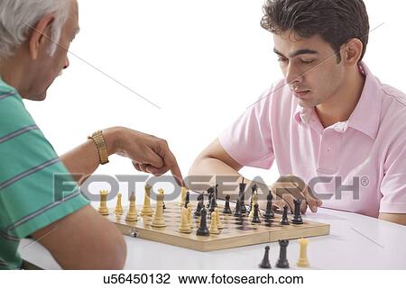 Grandfather and grandson playing chess View Large Photo Image Stock Image - Grandfather and grandson playing chess. Fotosearch