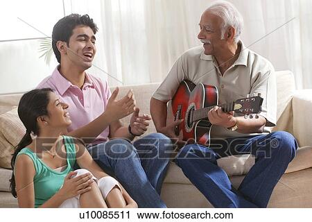 Grandfather playing the guitar and grandchildren singing View Large Photo Image Stock Image - Grandfather playing the guitar and grandchildren singing. Fotosearch