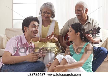 Grandfather playing the guitar and grandchildren singing View Large Photo Image Stock Photo - Grandfather playing the guitar and grandchildren singing. Fotosearch