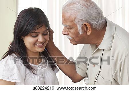 Grandfather pulling ears of granddaughter View Large Photo Image Stock Photo - Grandfather pulling ears of granddaughter. Fotosearch