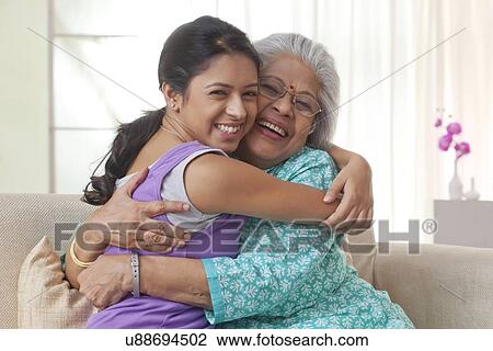Grandmother and granddaughter hugging each other View Large Photo Image Stock Image - Grandmother and granddaughter hugging each other. Fotosearch