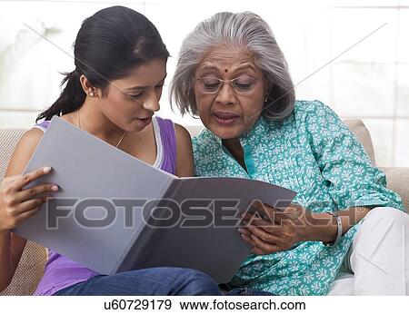Grandmother and granddaughter reading together View Large Photo Image Stock Photo - Grandmother and granddaughter reading together. Fotosearch