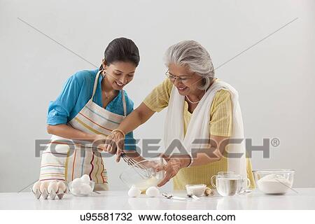 Grandmother and granddaughter working in the kitchen View Large Photo Image Stock Image - Grandmother and granddaughter working in the kitchen. Fotosearch