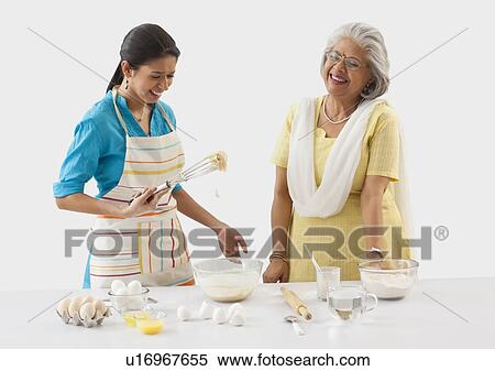 Grandmother and granddaughter working in the kitchen View Large Photo Image Stock Photography - Grandmother and granddaughter working in the kitchen. Fotosearch