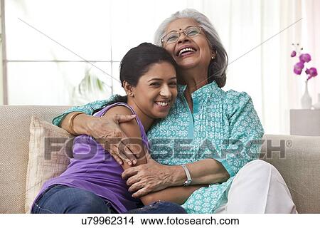 Picture - Grandmother hugging her granddaughter. Fotosearch
