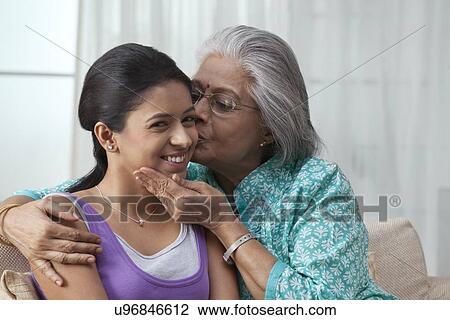 Grandmother kissing her granddaughter View Large Photo Image Stock Image - Grandmother kissing her granddaughter. Fotosearch