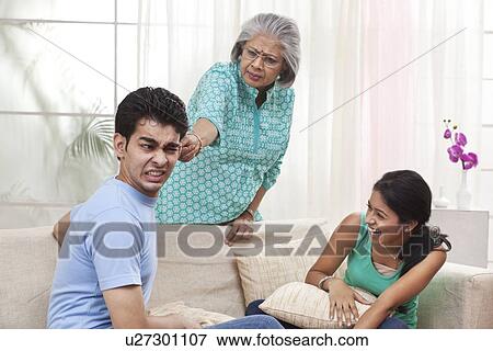 Grandmother reprimanding boy while girl rejoices View Large Photo Image Stock Photo - Grandmother reprimanding boy while girl rejoices. Fotosearch