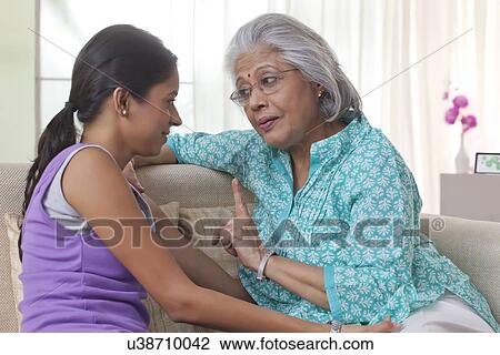 Grandmother talking to her granddaughter View Large Photo Image Stock Image - Grandmother talking to her granddaughter. Fotosearch