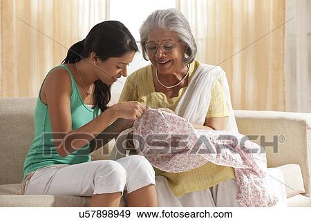 Grandmother teaching granddaughter how to sew View Large Photo Image Stock Photo - Grandmother teaching granddaughter how to sew. Fotosearch