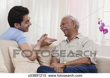 Stock Photography - Grandson and grandfather talking. Fotosearch