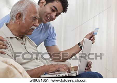 Grandson teaching grandfather how to operate laptop View Large Photo Image Stock Image - Grandson teaching grandfather how to operate laptop. Fotosearch