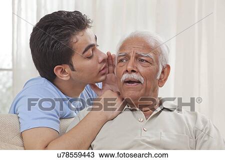 Grandson whispering into grandfather's ear View Large Photo Image Stock Image - Grandson whispering into grandfather's ear. Fotosearch