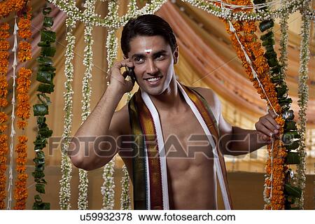 Groom having conversation on cell phone and looking away View Large Photo Image Stock Photo - Groom having conversation on cell phone and looking away . Fotosearch