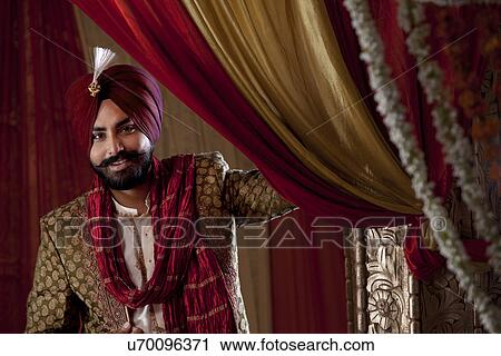 Groom wearing traditional Sikh wedding costume View Large Photo Image Stock Image - Groom wearing traditional Sikh wedding costume . Fotosearch