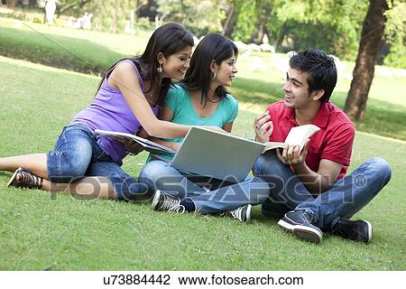 Group of happy friends sitting in lawn View Large Photo Image Stock Image - Group of happy friends sitting in lawn . Fotosearch