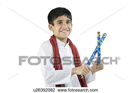 Stock Image - Gujarati boy with dandiya sticks . Fotosearch