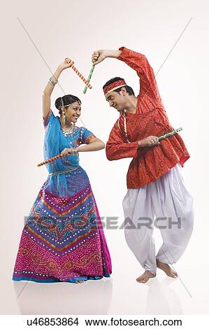 Gujarati couple performing dandiya View Large Photo Image Picture - Gujarati couple performing dandiya . Fotosearch