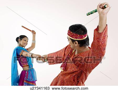 Gujarati couple performing dandiya View Large Photo Image Stock Image - Gujarati couple performing dandiya . Fotosearch