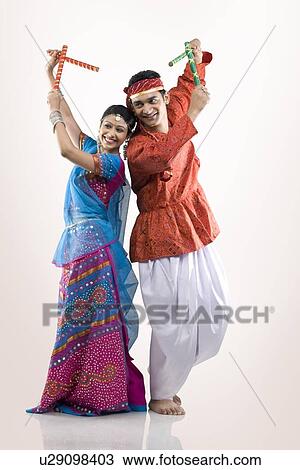 Gujarati couple performing dandiya View Large Photo Image Stock Image - Gujarati couple performing dandiya . Fotosearch