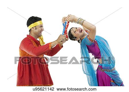Gujarati couple performing dandiya dance View Large Photo Image Stock Image - Gujarati couple performing dandiya dance . Fotosearch