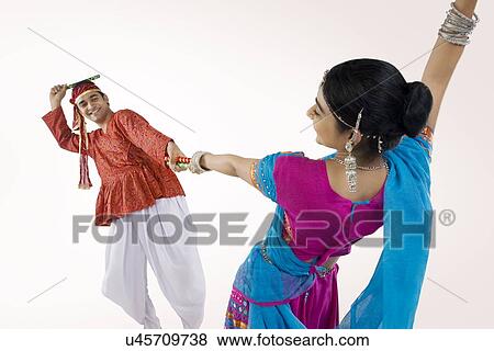 Gujarati couple performing dandiya View Large Photo Image Stock Photo - Gujarati couple performing dandiya . Fotosearch