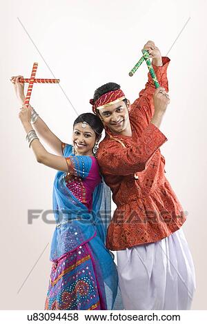 Gujarati couple performing dandiya View Large Photo Image Stock Photo - Gujarati couple performing dandiya . Fotosearch