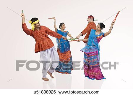 Gujarati couples performing dandiya View Large Photo Image Stock Photograph - Gujarati couples performing dandiya . Fotosearch