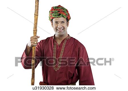 Gujarati man holding a stick View Large Photo Image Stock Photo - Gujarati man holding a stick . Fotosearch