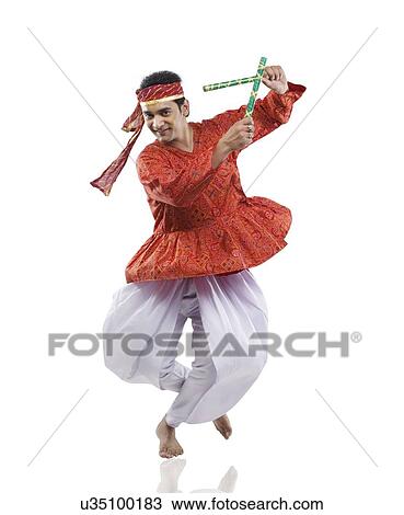 Gujarati man performing dandiya View Large Photo Image Stock Image - Gujarati man performing dandiya . Fotosearch