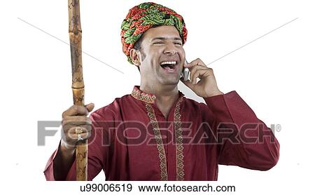 Stock Photo - Gujarati man talking on a mobile phone . Fotosearch