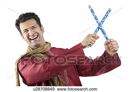 Stock Photo - Gujarati man with dandiya sticks . Fotosearch