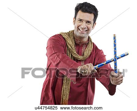 Gujarati man with dandiya sticks View Large Photo Image Stock Photography - Gujarati man with dandiya sticks . Fotosearch