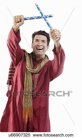 Gujarati man with dandiya sticks View Large Photo Image Stock Photography - Gujarati man with dandiya sticks . Fotosearch