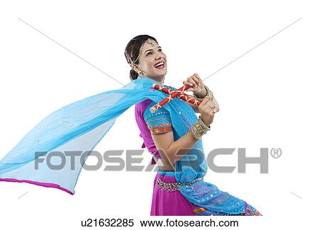 Gujarati woman dancing with dandiya sticks View Large Photo Image Stock Photography - Gujarati woman dancing with dandiya sticks . Fotosearch