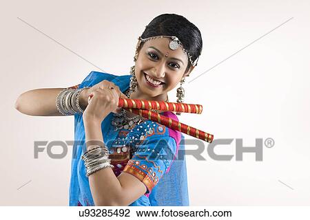 Stock Image - Gujarati woman performing dandiya . Fotosearch