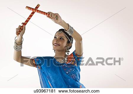 Stock Image - Gujarati woman performing dandiya . Fotosearch