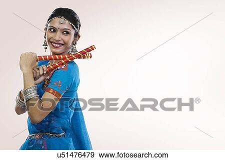 Stock Photo - Gujarati woman performing dandiya . Fotosearch