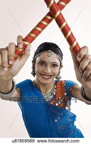 Stock Photo - Gujarati woman performing dandiya . Fotosearch