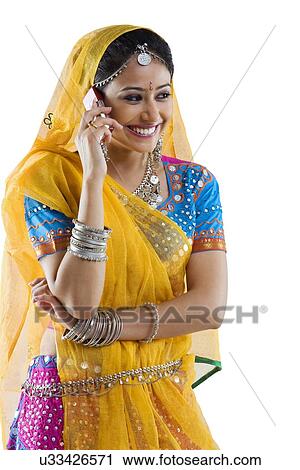 Gujarati woman talking on a mobile phone View Large Photo Image Stock Image - Gujarati woman talking on a mobile phone . Fotosearch