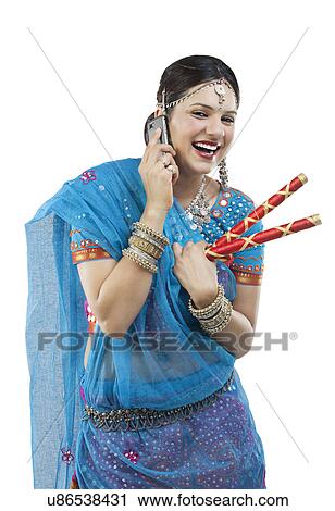 Gujarati woman talking on a mobile phone View Large Photo Image Stock Image - Gujarati woman talking on a mobile phone . Fotosearch