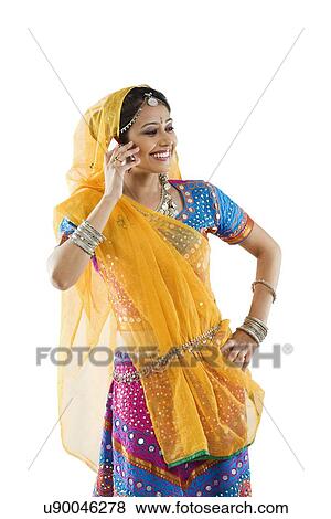 Gujarati woman talking on a mobile phone View Large Photo Image Stock Photo - Gujarati woman talking on a mobile phone . Fotosearch