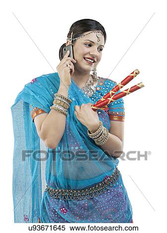 Gujarati woman talking on a mobile phone View Large Photo Image Stock Photography - Gujarati woman talking on a mobile phone . Fotosearch