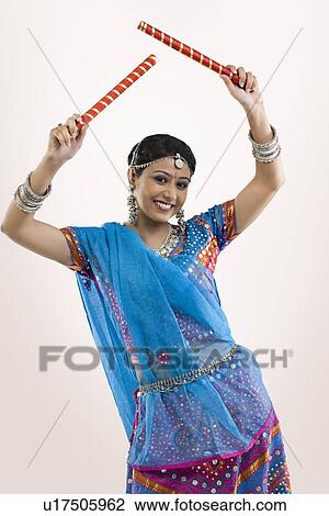 Gujarati woman with dandiya sticks View Large Photo Image Stock Image - Gujarati woman with dandiya sticks . Fotosearch